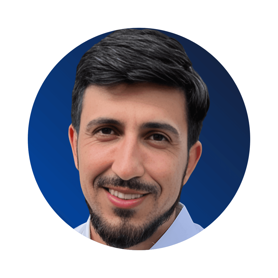 Portrait of a smiling man with dark hair and beard on a blue background.