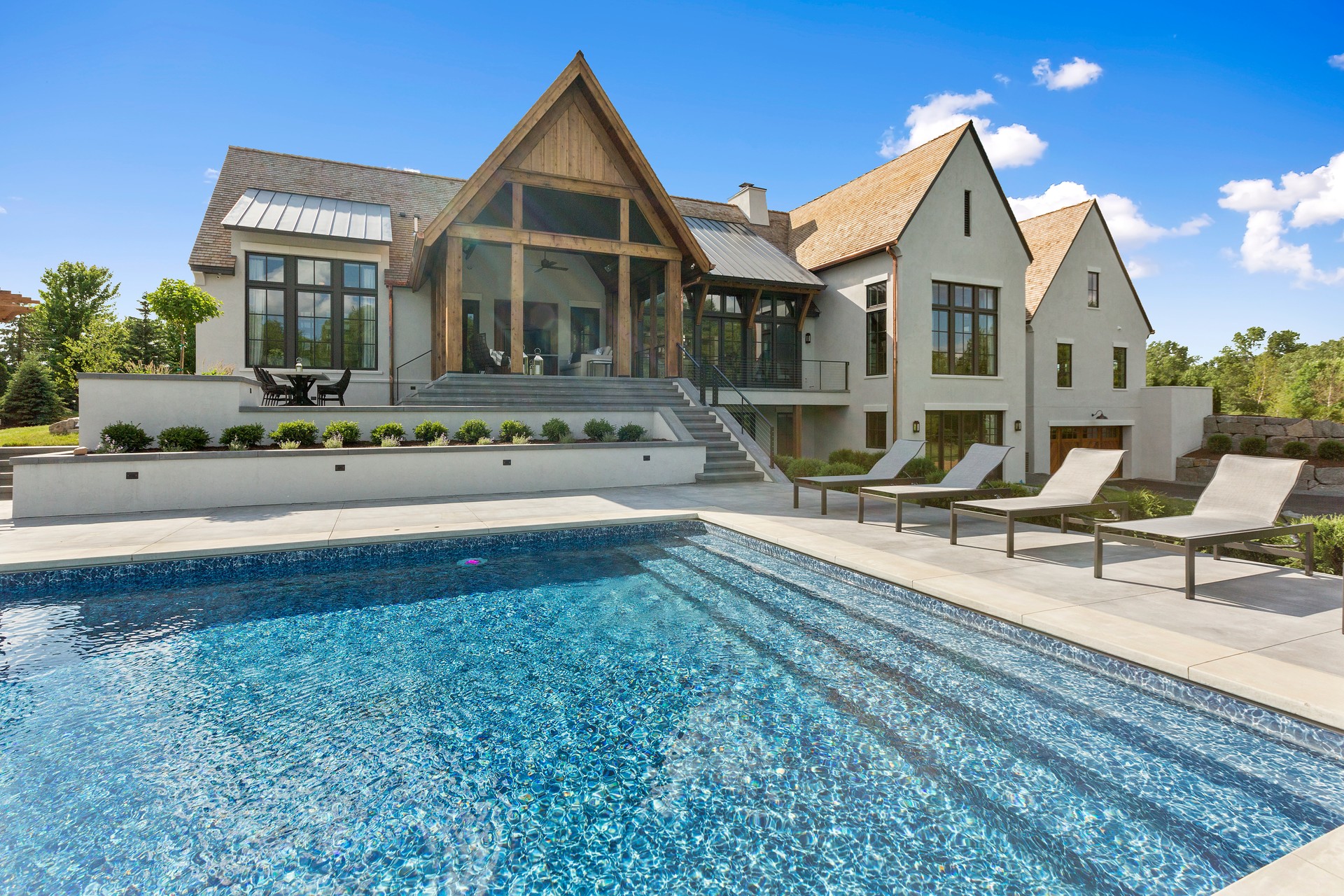 Beautiful day to be spent poolside in the back of your luxury home